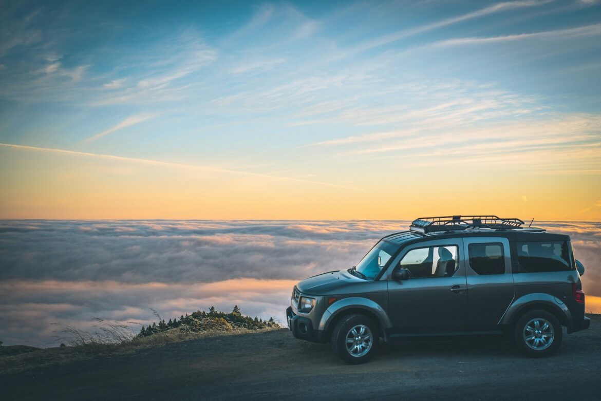 car on roadtrip parked along sunset canyon